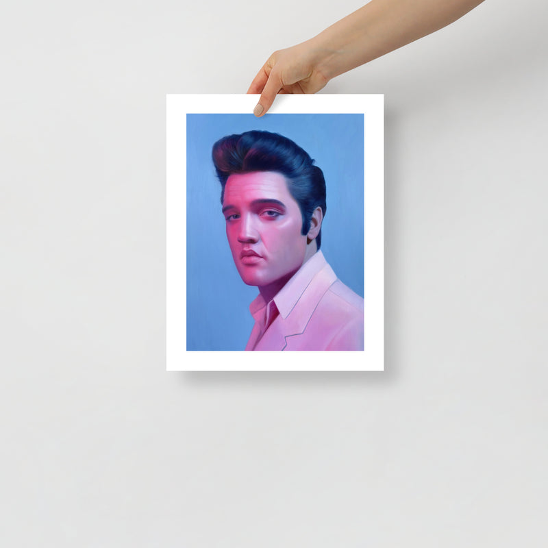 MEFREEK Seth Jennemann Open Edition Print hyper realistic portrait of Elvis Presley with signature pompadour and smooth pink and blue lighting, shown as a physical fine art print held by a hand against a clean minimal background