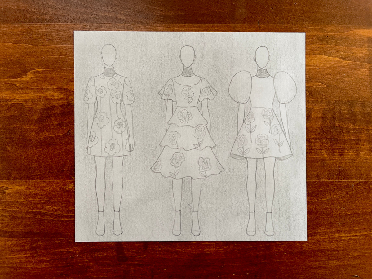 Seth Jennemann MEFREEK — A Smile That Came With Strings Attached, graphite pencil fashion illustration in conceptual sketch style. Three faceless figures model short dresses with oversized puff sleeves, layered ruffles, and bold floral patterns inspired by the portrait’s motif. croquis