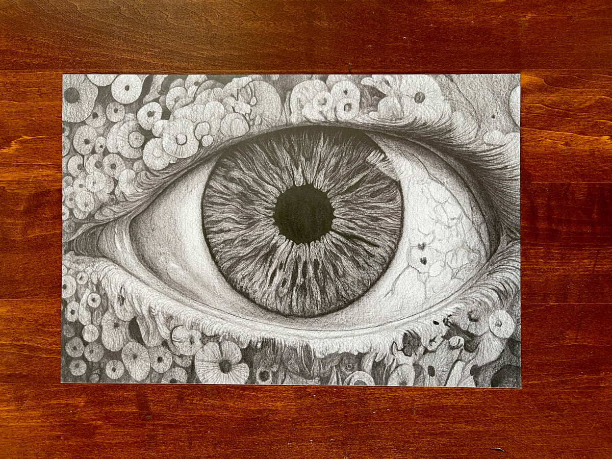 Seth Jennemann MEFREEK — Everything's Fine If You Name It Something Else, graphite pencil drawing in hyperreal surrealist style. A large, detailed human eye surrounded by organic circular textures stares outward, blending microscopic intricacy with emotional intensity in precise monochrome realism.