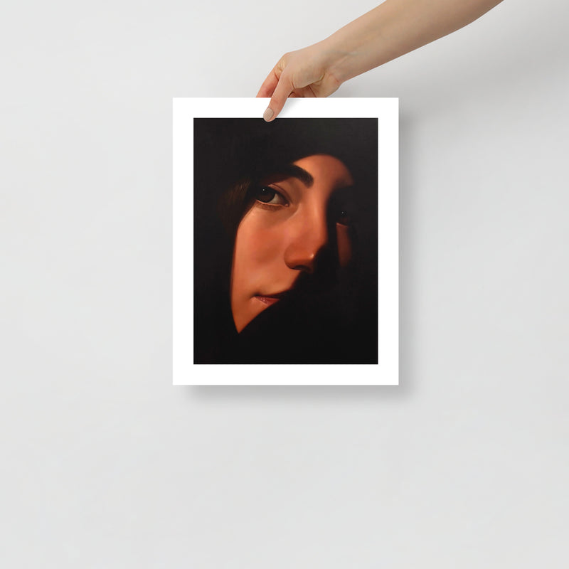 MEFREEK Seth Jennemann Open Edition Art Prints Indoor Thoughts With The Windows Down – Unframed fine art print held by hand against a light gray background, featuring a dramatic portrait of a woman with dark hair, expressive brown eyes, and softly lit warm skin, her face partially disappearing into deep black shadows, surrounded by a white border.