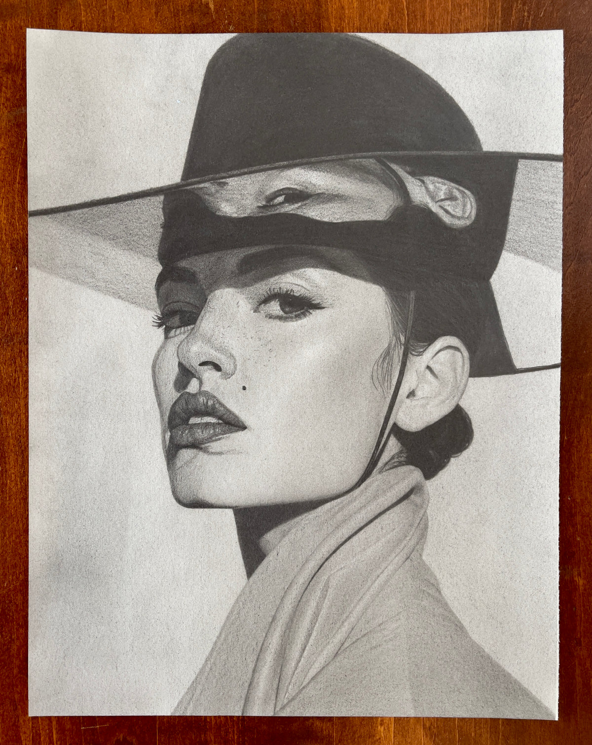 MEFREEK Seth Jennemann Original Pencil Drawing Kept The Change And Called It Me – Realistic graphite pencil portrait of a woman wearing a traditional Korean-inspired wide-brimmed black hat with a tall, structured crown and a dark translucent face covering that reveals her eyes beneath the brim. Her head is turned in a three-quarter view, with her chin slightly raised and her gaze directed toward the viewer. She has carefully defined eyebrows, long eyelashes, softly shaded cheekbones, full lips, and a small 