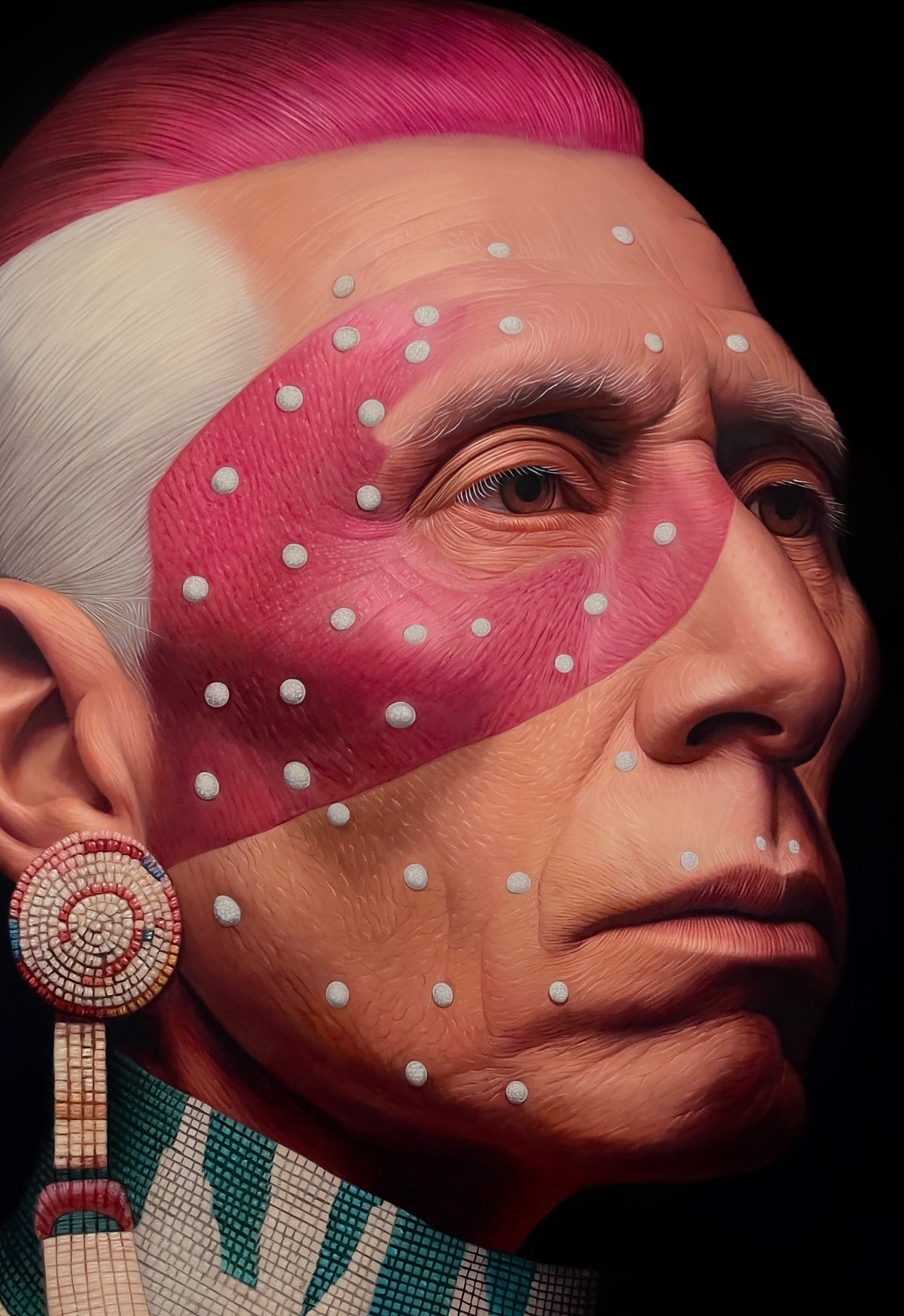 MEFREEK Seth Jennemann Original Oil Painting hyperrealistic close up portrait of a Native American man in profile featuring vivid pink face paint across the eyes and upper cheeks with evenly spaced white dot markings finely rendered skin texture with wrinkles and pores a detailed eye and natural expression a circular beaded earring with intricate geometric patterns and hanging elements and a patterned garment with turquoise and neutral tones set against a deep black background with dramatic lighting emphasi