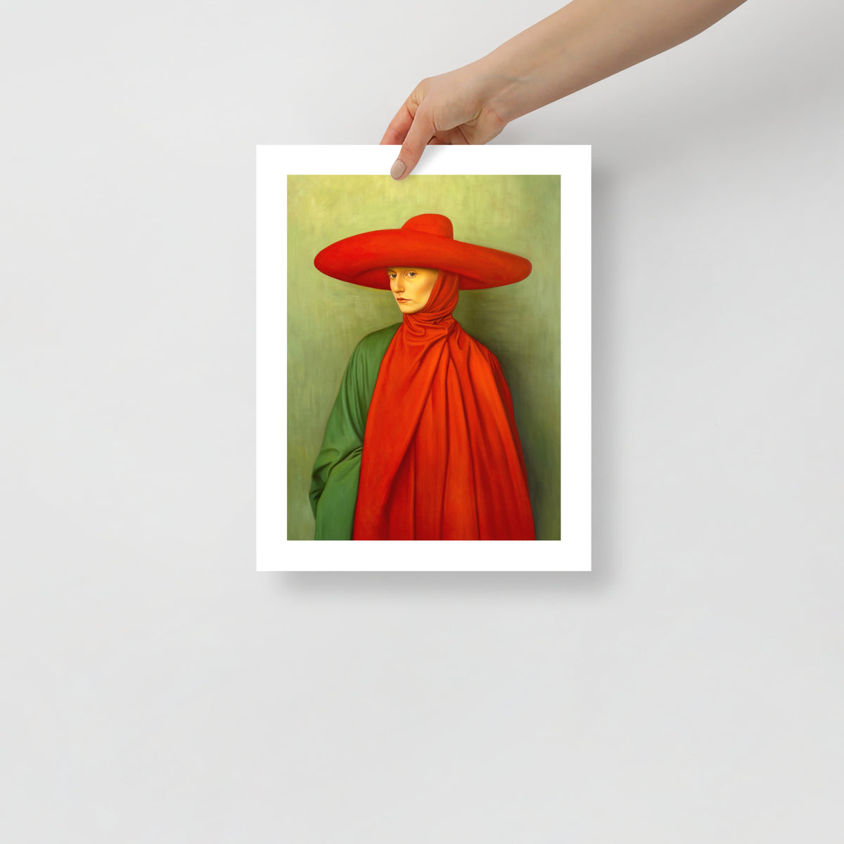 MEFREEK Seth Jennemann Open Edition Print The Linger Of Apology presents a hyperreal portrait framed in black, emphasizing the figure’s crimson drapery and hat against a subdued green field. The striking color balance and minimalist setting convey restraint, shame, and misplaced sanctity in MEFREEK’s signature surreal realism.