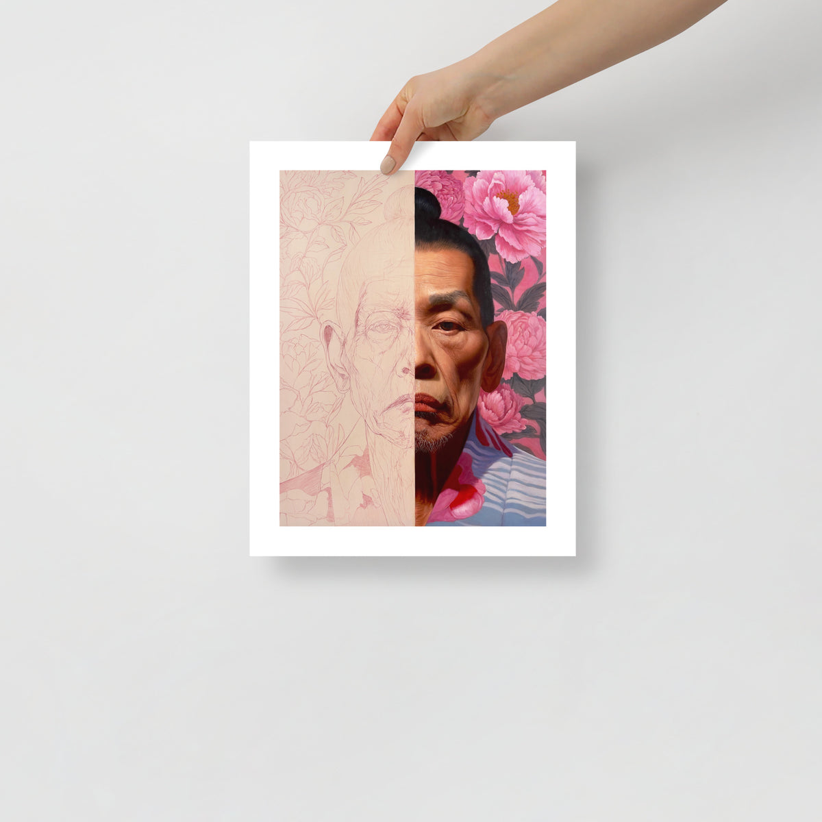 MEFREEK Seth Jennemann Open Edition Art Prints The Truth Shall Prevail – Unframed fine art portrait print held by hand against a light gray background. The artwork depicts an older Asian man with dark hair tied in a topknot, his face divided vertically between a delicate pink line drawing and a fully rendered realistic portrait. Intricate floral outlines fill the unfinished half, while vibrant pink peonies and dark foliage surround the completed half.