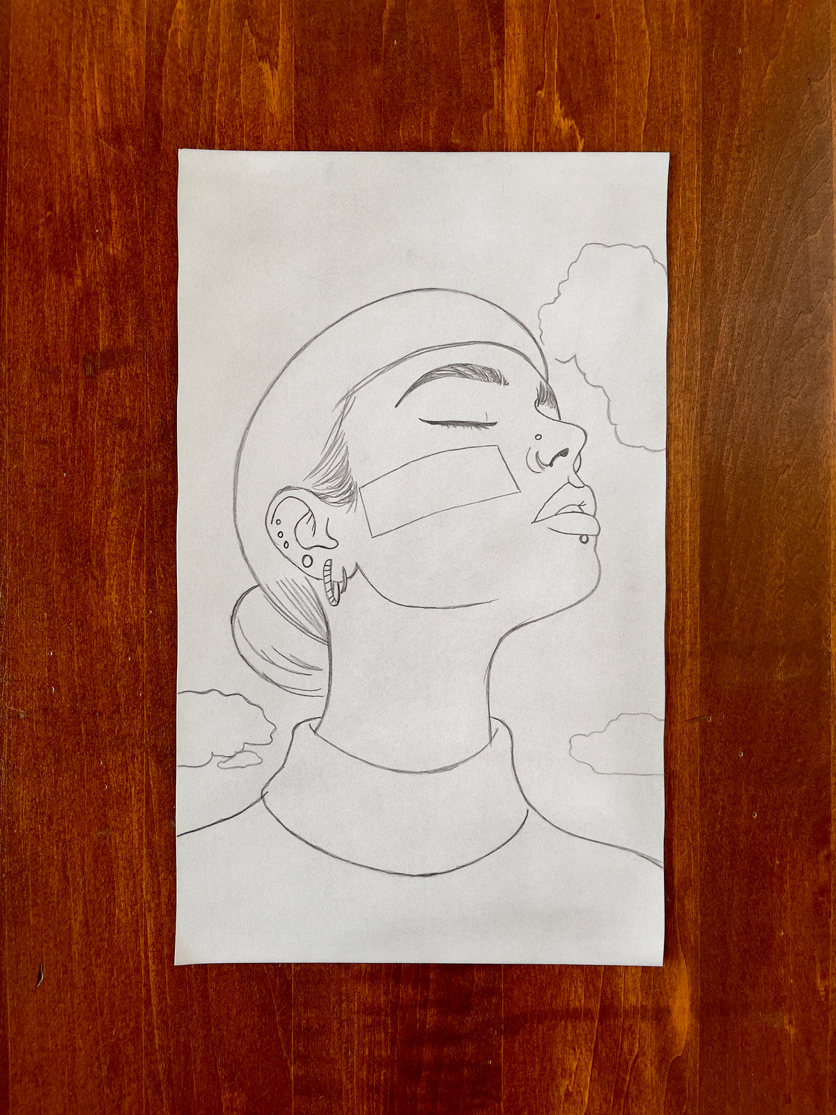 Seth Jennemann MEFREEK - The Weight Of Being Weightless - pencil drawing in minimalist contemporary portrait style showing a serene woman in profile with closed eyes, geometric facial bands, piercings, and clouds in the background.
