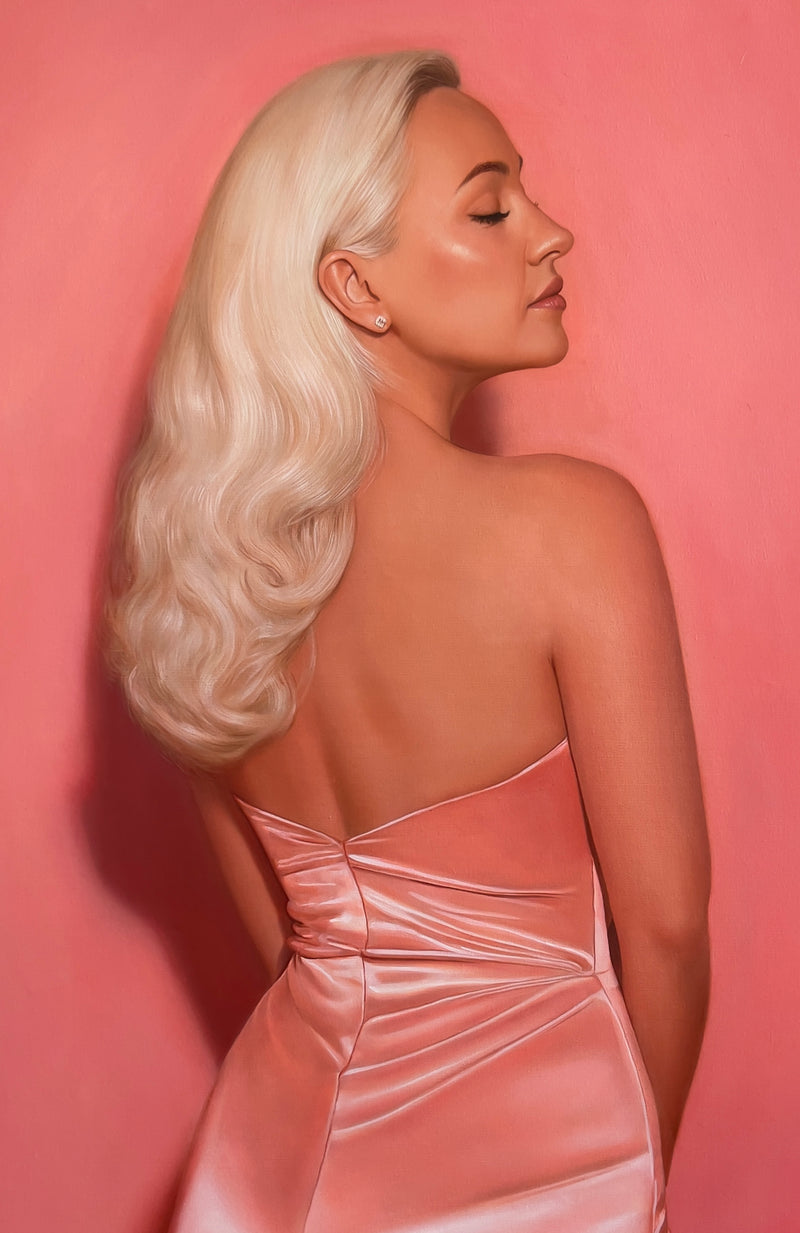 MEFREEK Seth Jennemann Original Oil Painting "Two For The Price Of Two" featuring a three-quarter rear view of a blonde woman wearing an elegant, backless blush pink satin dress. Her platinum blonde hair falls in voluminous waves over one shoulder as she turns her head in profile with her eyes gently closed. Delicate highlights emphasize the glossy fabric, sculpted shoulders, and softly illuminated skin against a warm pink background.