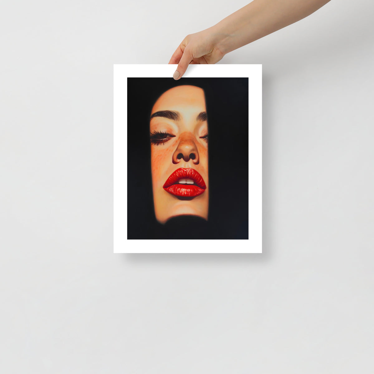 MEFREEK Seth Jennemann Open Edition Print Unstable At Close Range unframed art print held by hand showing a detailed close-up of a woman’s face emerging from black, rich red lips and smooth skin tones rendered in hyperreal pop surrealist style.