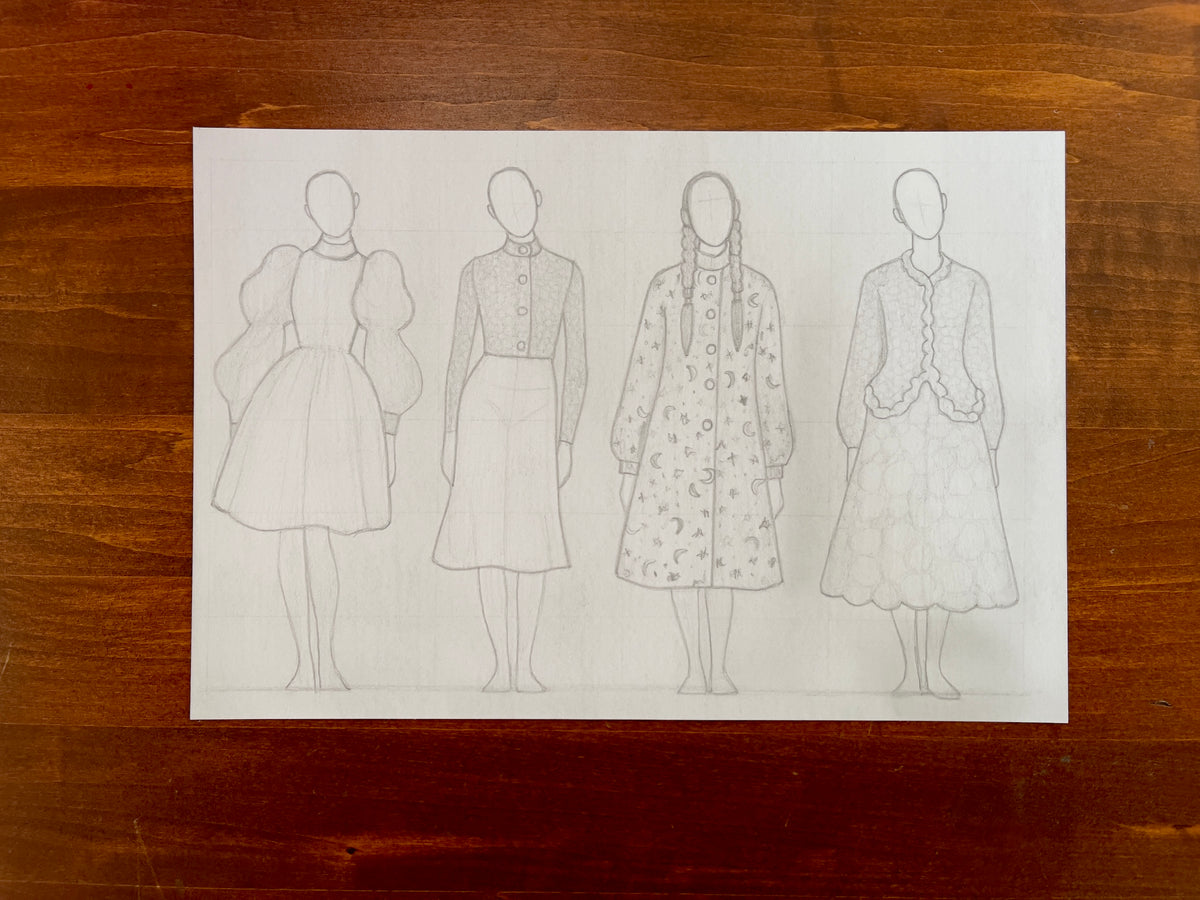 Seth Jennemann MEFREEK — Unholy Choirs and Unwanted Updates, graphite pencil fashion illustration in contemporary sketch style. Four faceless figures display conceptual designs featuring puff-sleeved dresses, tailored buttoned tops, a celestial patterned coat, and textured skirts, all drawn with refined shading on a light paper background.