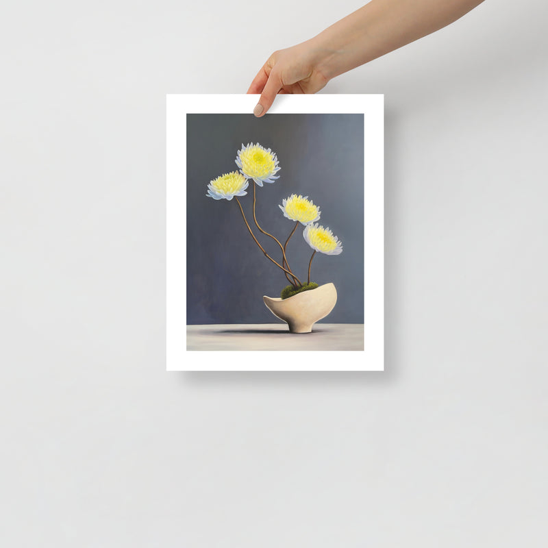 MEFREEK Seth Jennemann Open Edition Print minimalist floral still life featuring white and yellow blooms with slender stems in a sculptural ceramic vase, shown as a physical fine art print held by a hand against a clean neutral background