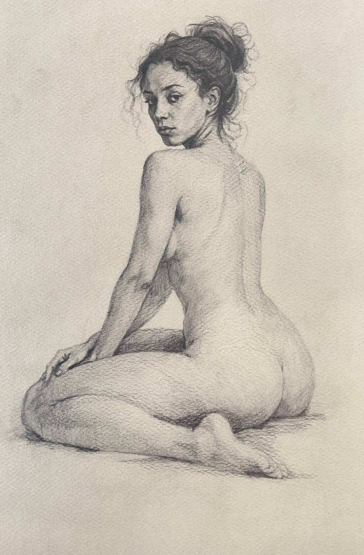 MEFREEK Seth Jennemann Graphite Pencil Drawing of a seated nude female figure viewed from behind, turning her head over her shoulder, with delicate anatomical rendering, soft tonal transitions, and subtle paper texture enhancing depth and realism