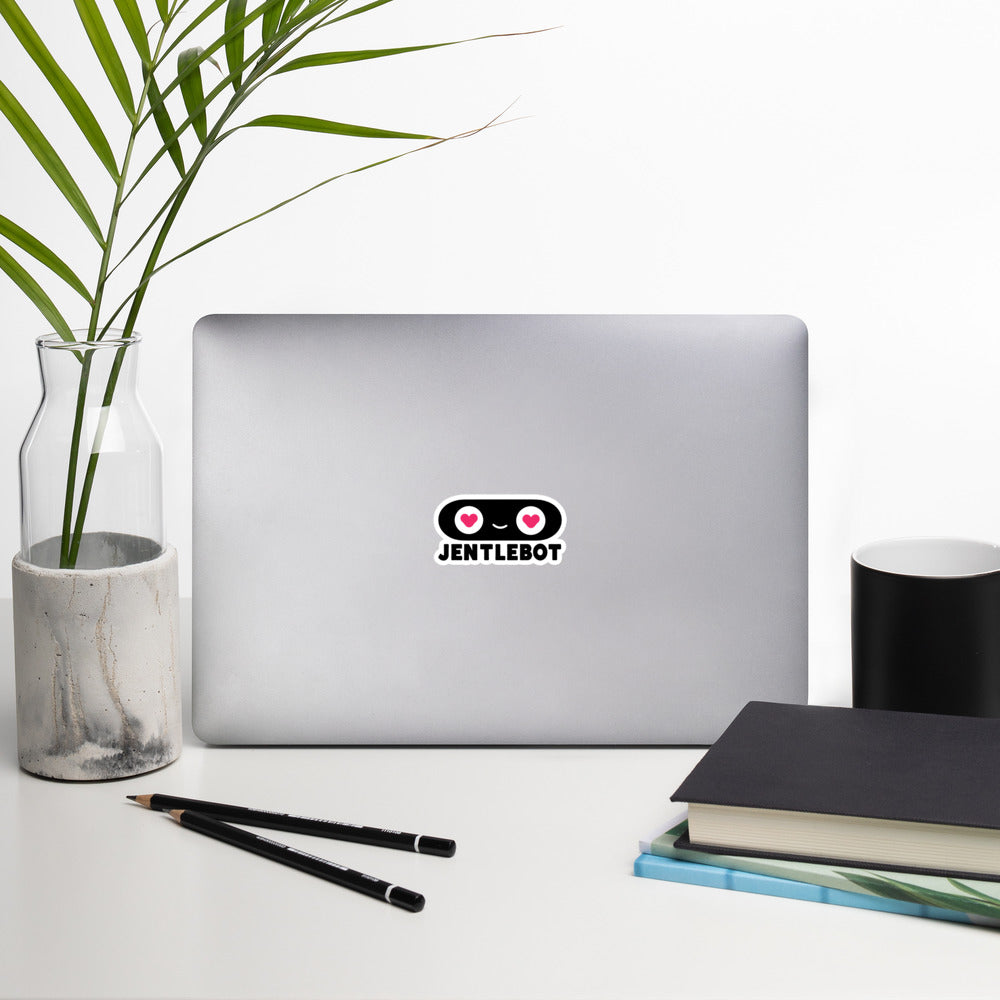 Laptop with a dog sticker on a desk with a plant, pencils, and books.