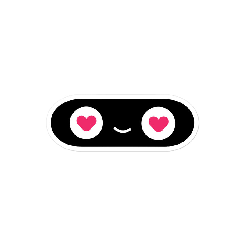 Black oval with white center, pink hearts, and a small smiley face on a white background