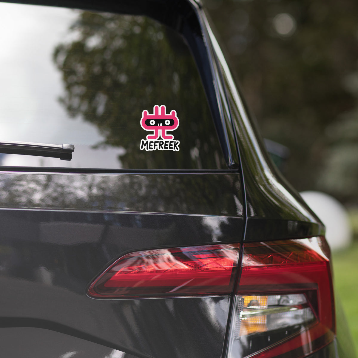 Car with a decal on the rear window, featuring a logo and text.