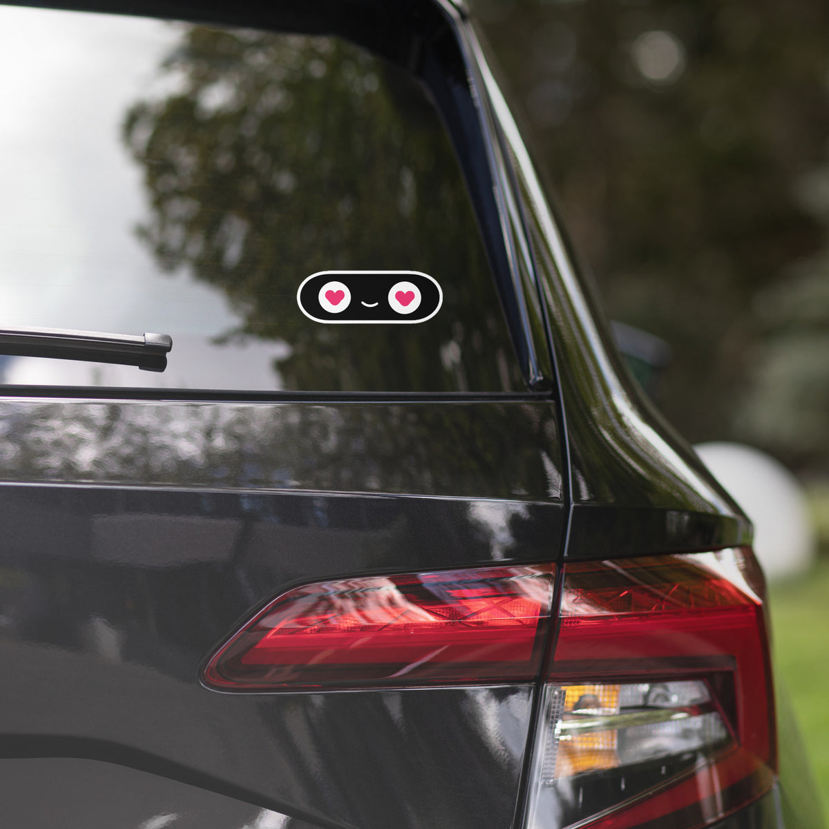 Close-up of a car's rear end with a blurred natural background