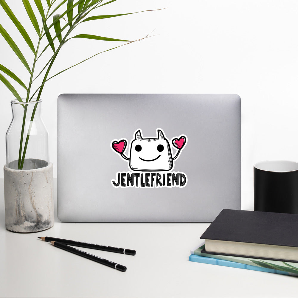 Laptop with a sticker on a desk with a plant, pencils, and books.